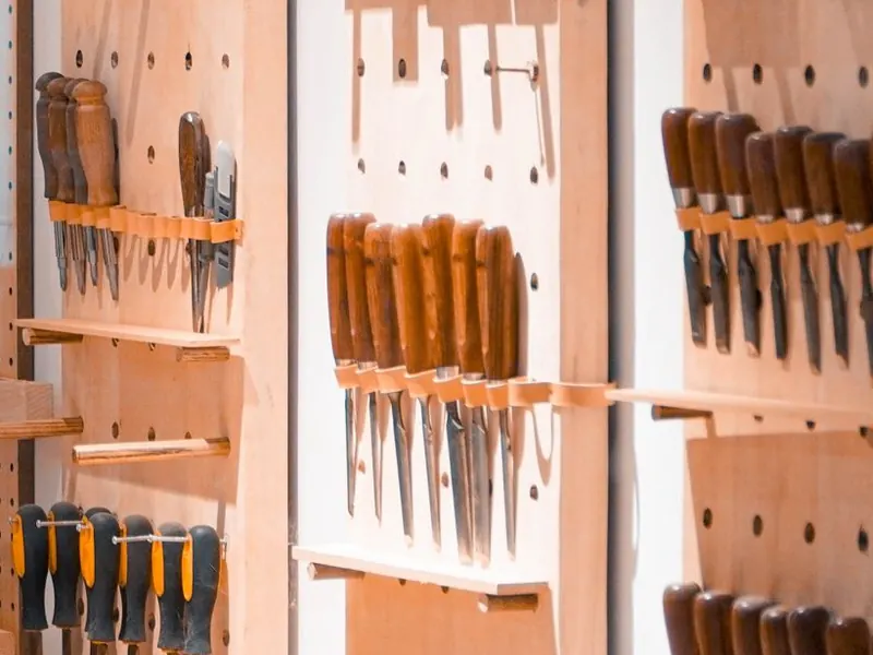 Wall-mounted tool storage system in an organized workshop