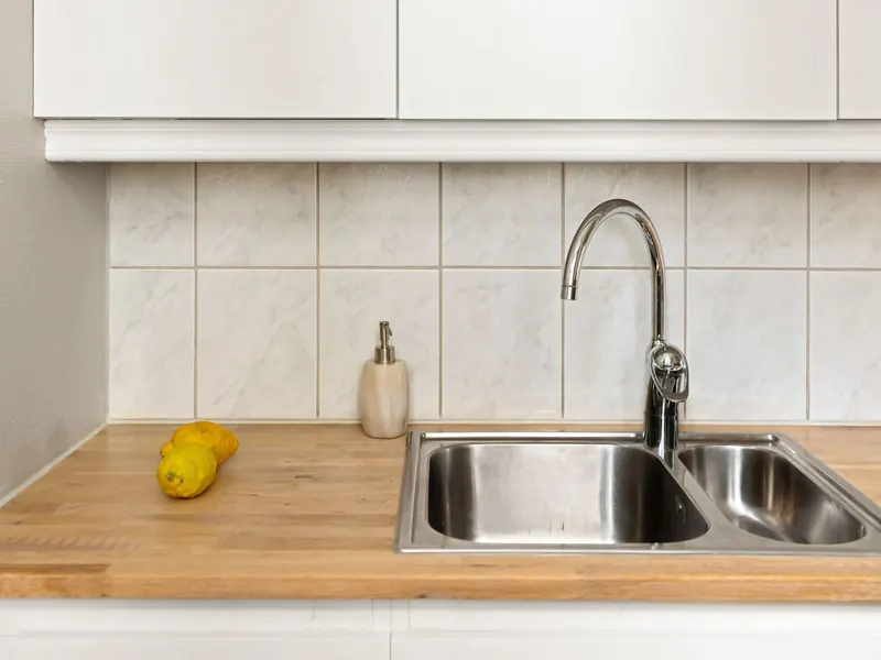 Kitchen sink with a chrome faucet